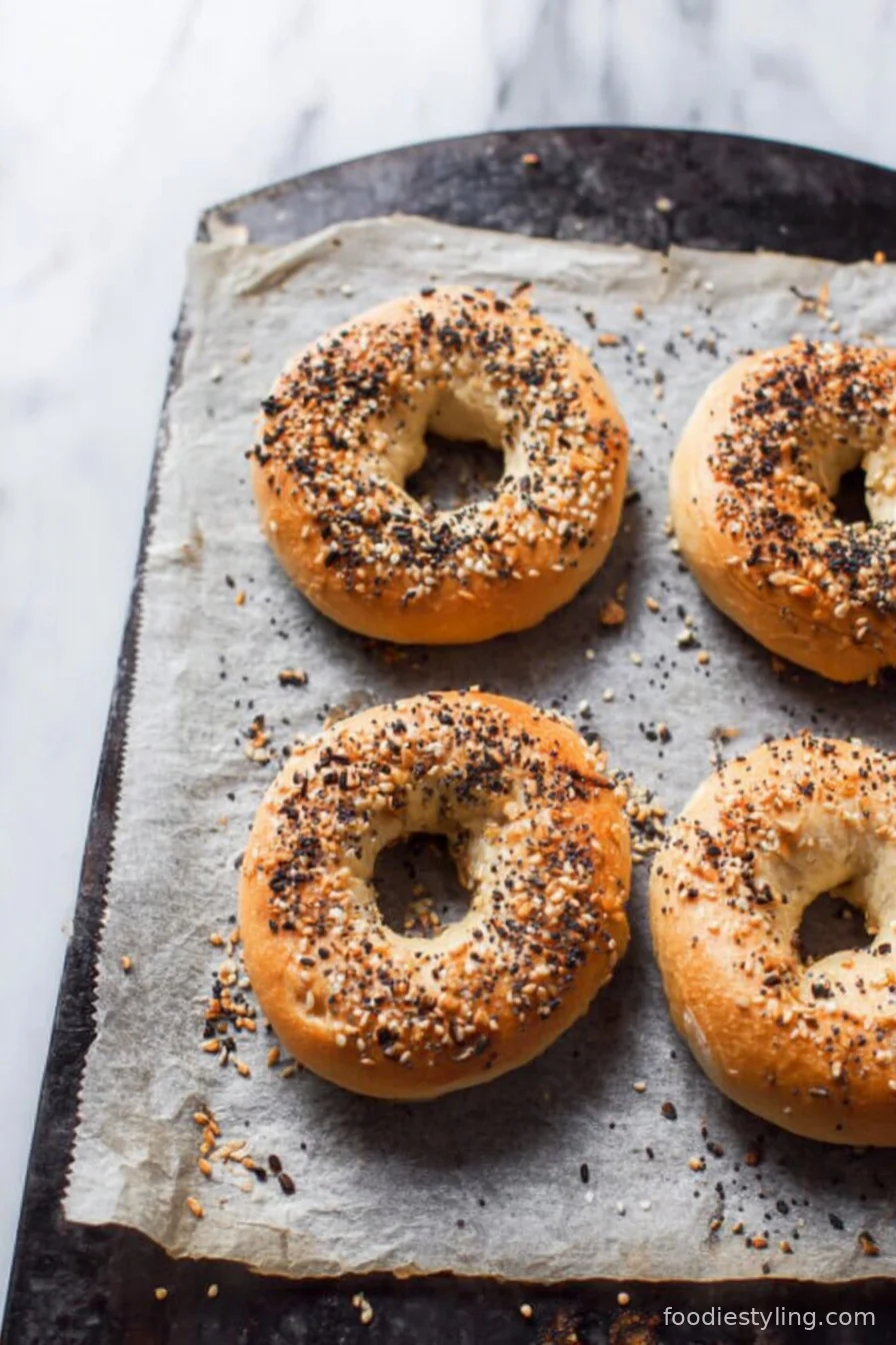 Freshly baked Greek yogurt bagels on a wire rack with a golden crust and soft interior.