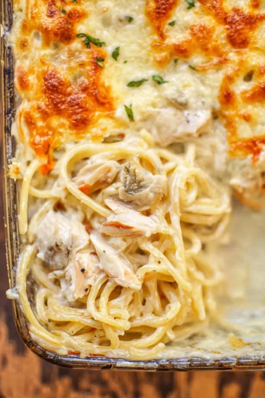Creamy Chicken Tetrazzini bubbling in a casserole dish, topped with golden cheese.